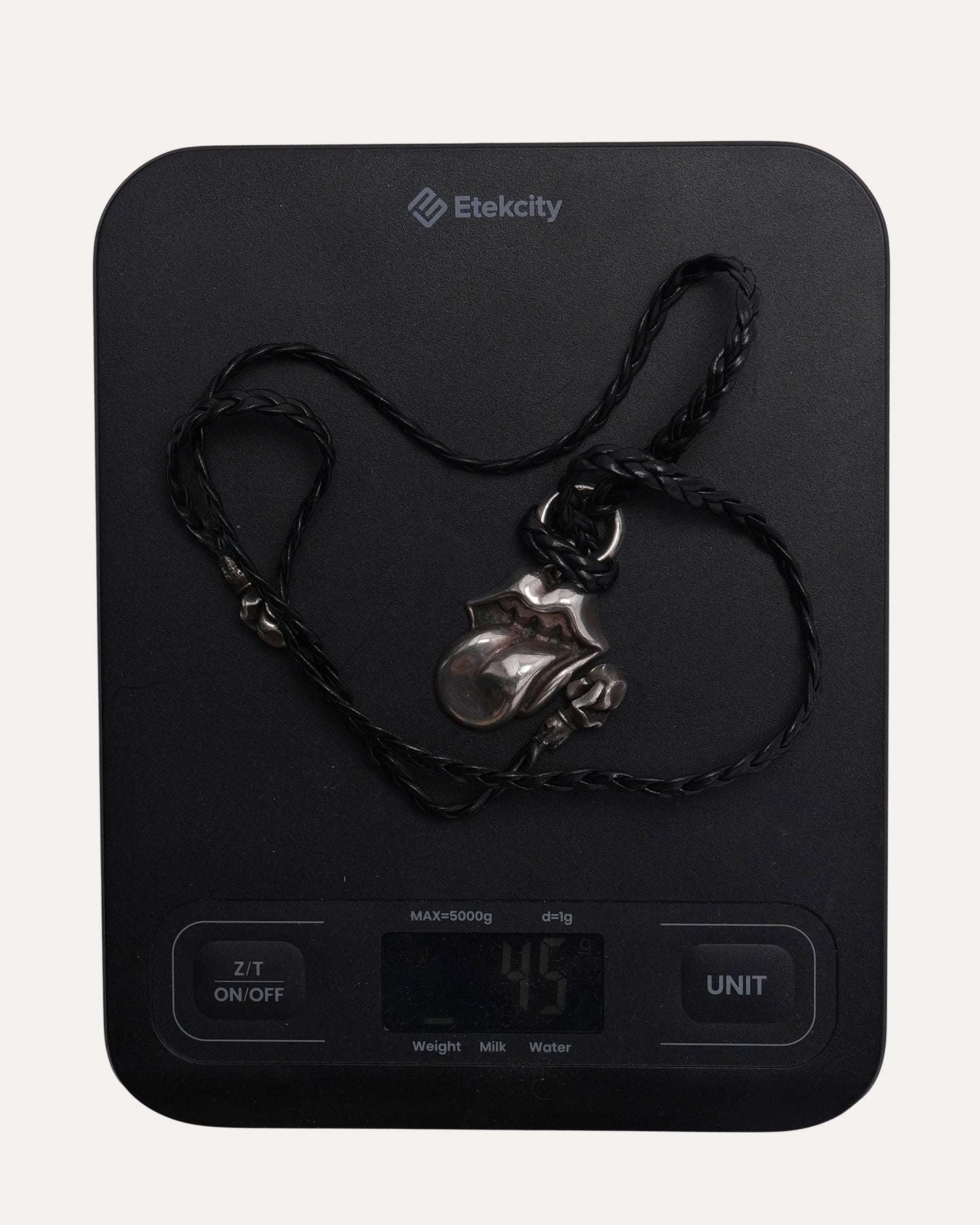 Rolling Stones Pendant on Braided Leather Necklace