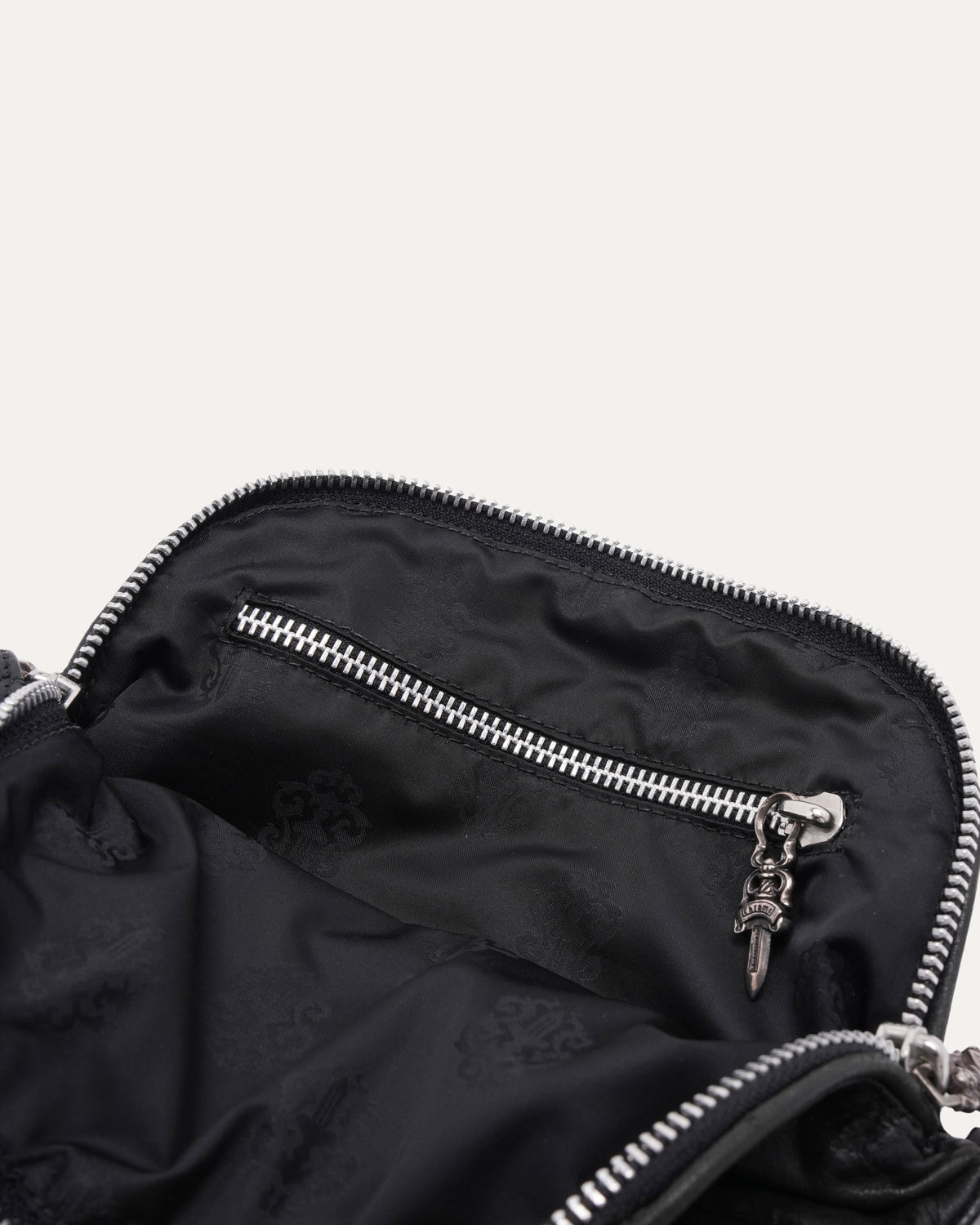 Dagger Embellished Grommet Crossbody Bag